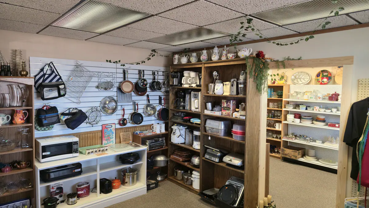 A wall of pans, kitchen goods and shelves of housewares