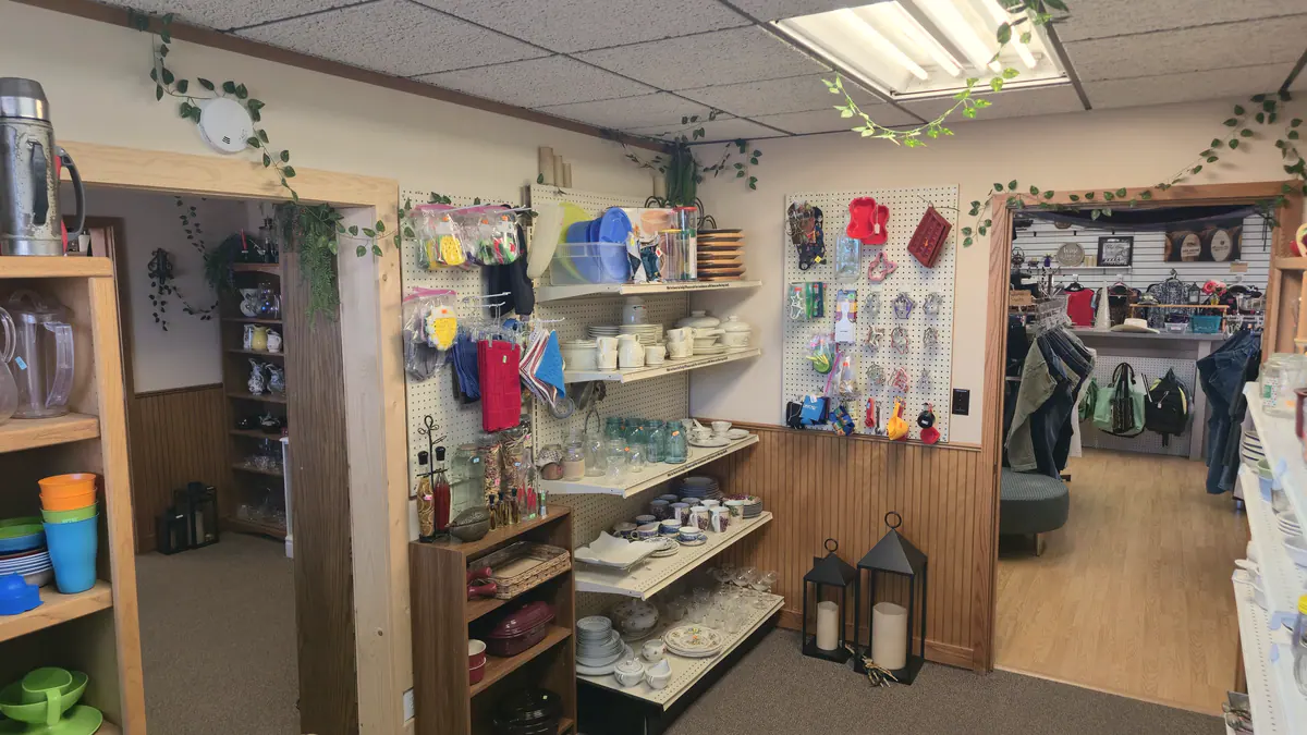 The front room with towels, kitchen goods and shelves leading to the clothing room