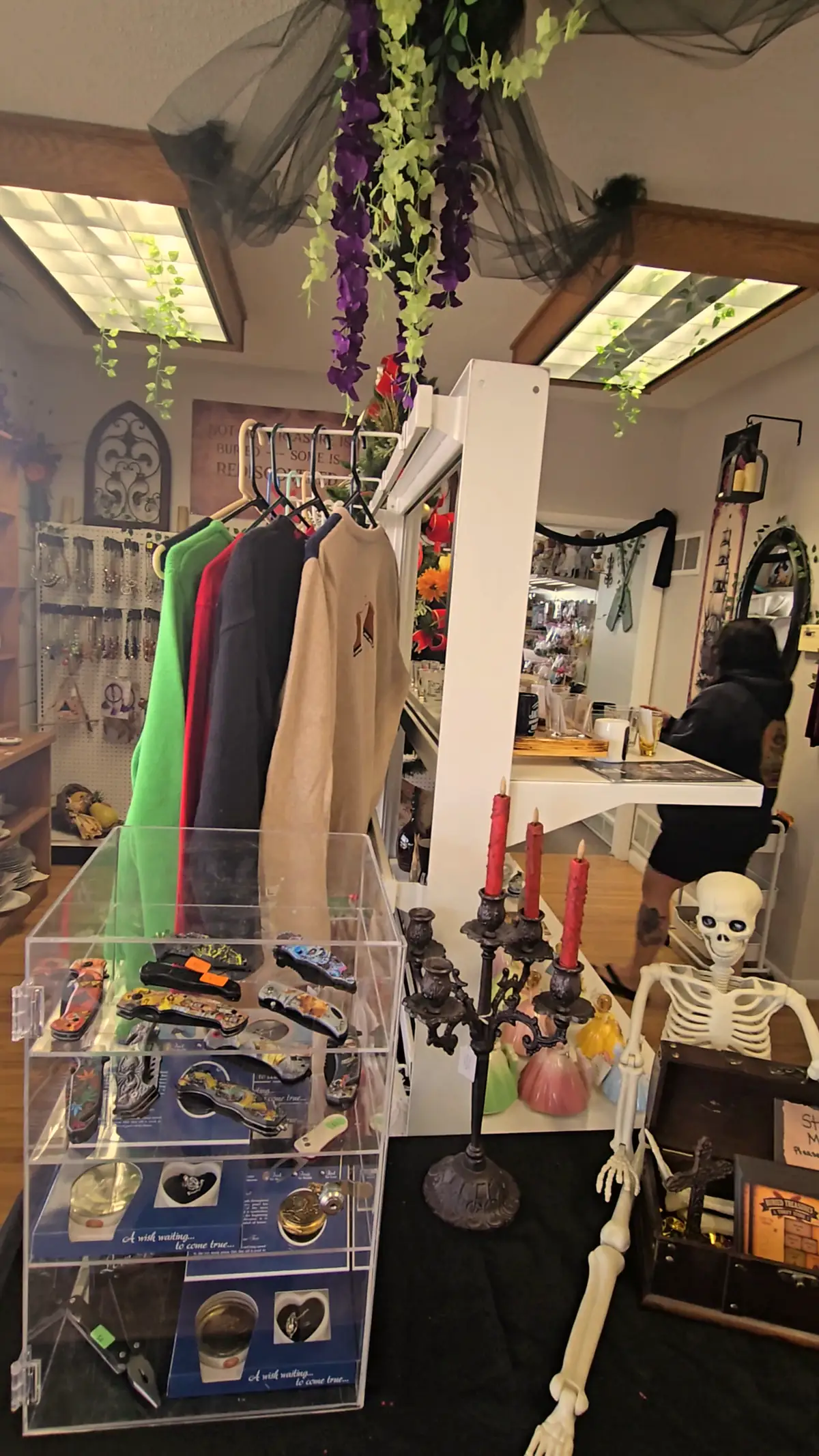 A jewelry case, jackets and a skeleton by the counter