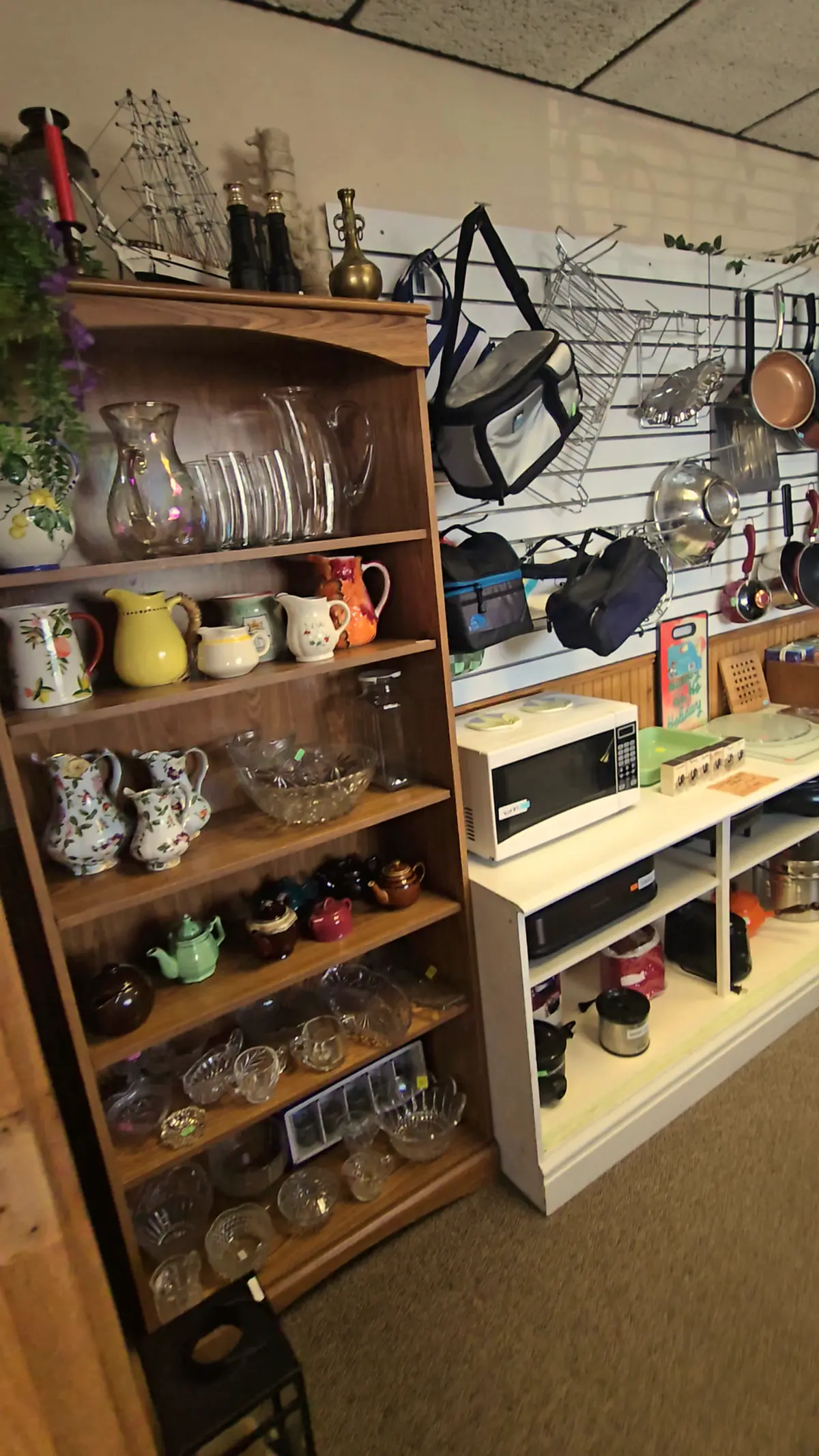 Shelves of glassware, teapots and kitchen goods