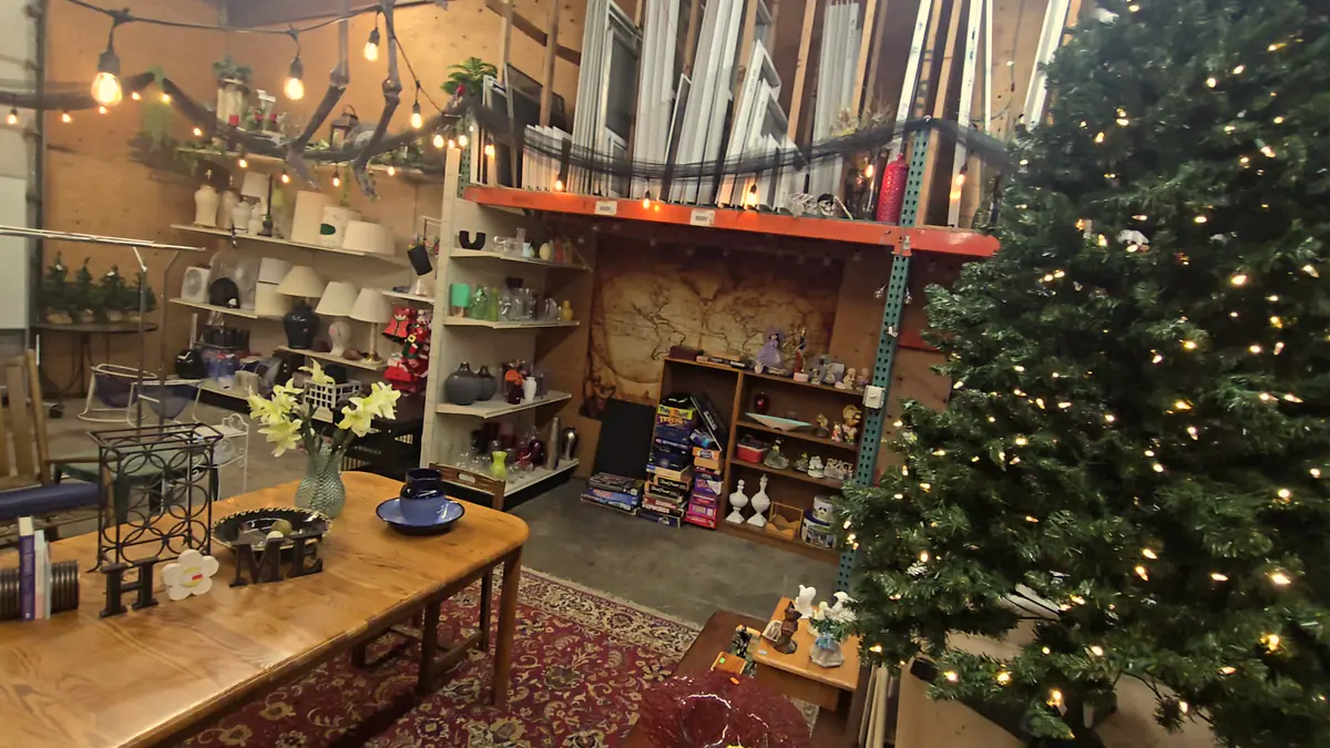 The warehouse room with rugs, furniture and a lit tree